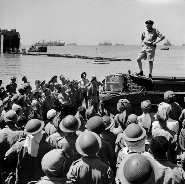 A British general is shown speaking to Canadian troops in the Sicilian region of Italy during the Second World War.