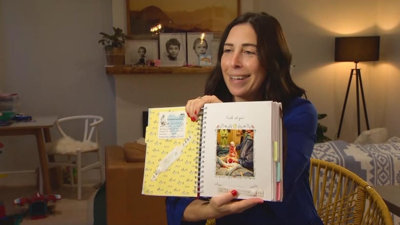 Woman holds photo of a baby