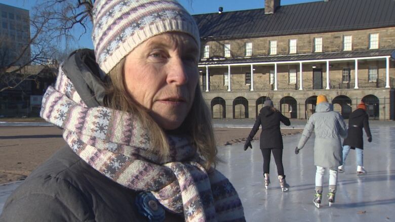 Kate Rogers stands on the ice at the skating track in Officers' Square.