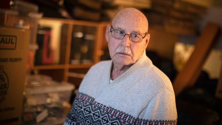 A 75-year-old man pictured indoors with his moving boxes in his apartment in Langley, British Columbia.