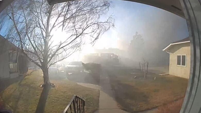 The view from Lethbridge city councillor Mark Campbell's ring camera as three houses across the street burned in the early afternoon of Boxing Day.