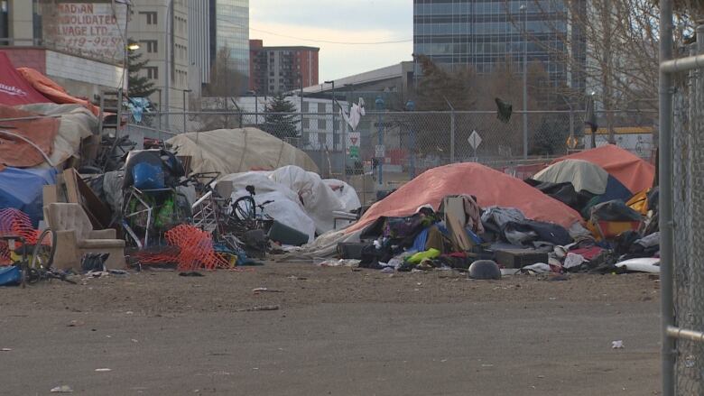 Tents set up amid heaps of material.