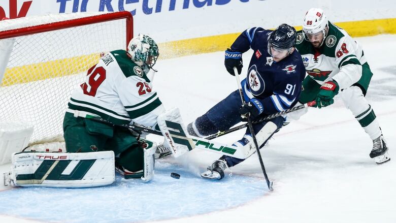 A goalie makes a save in front of the net.