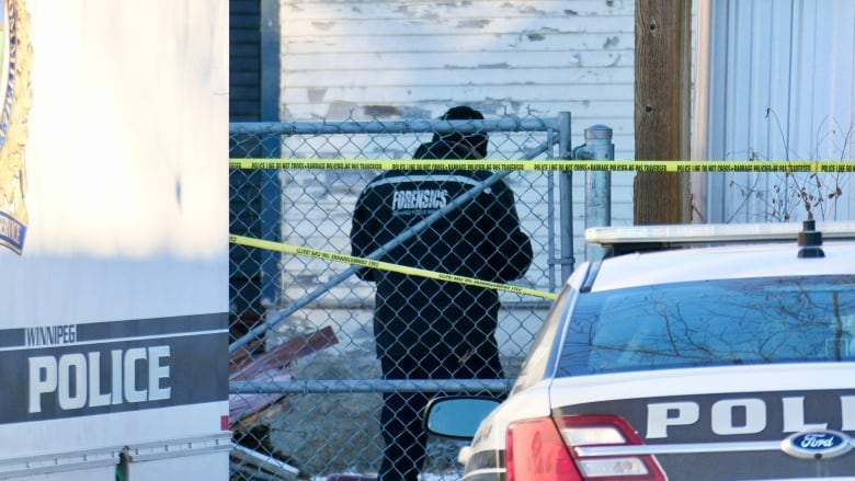 A police forensics unit truck is pictured between two cop cars.