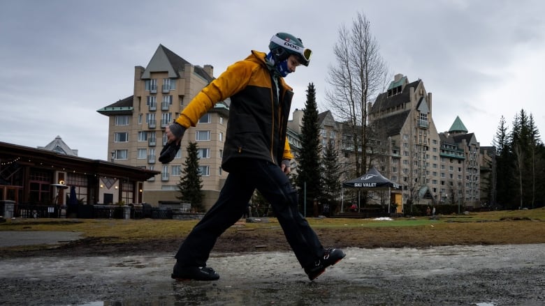 A person walks through a slush puddle.