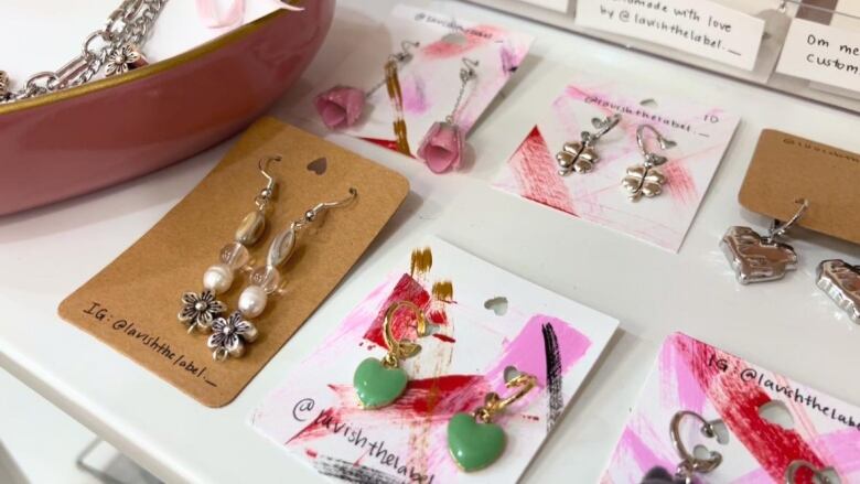 some earrings on a white shelf.