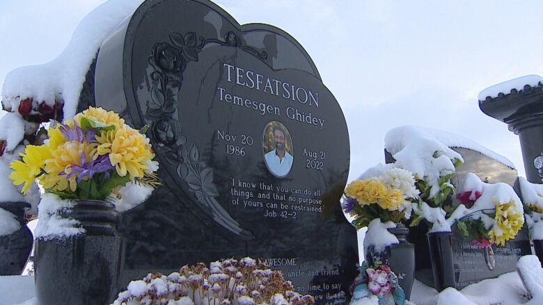 A headstone with a photo of a man in his 30s. 