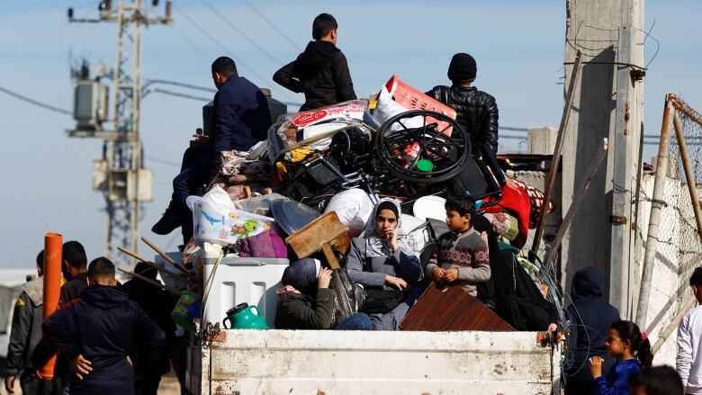 People ride in a truck in Gaza.