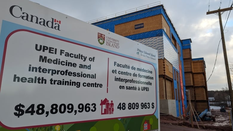 A building under construction is shown in the background with a sign reading UPEI Faculty of Medicine interprofessional health training centre in the foreground.