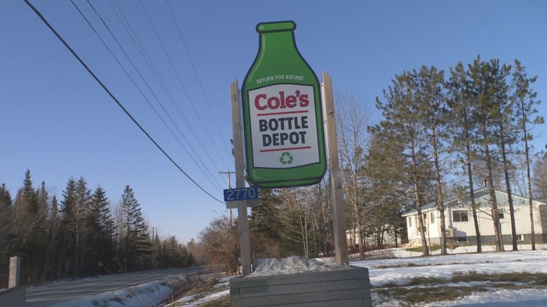 A green sign that looks like a bottle. It reads Cole's Bottle Depot