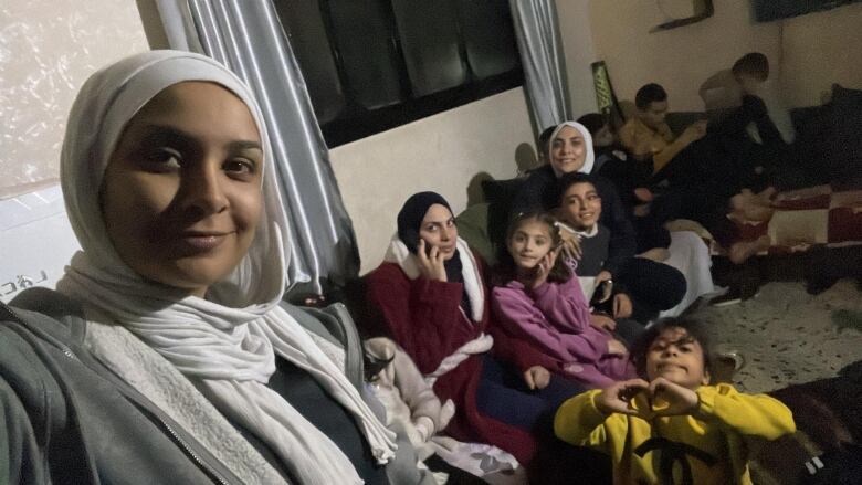 Some of Rami Aljadba's family in an apartment in Deir Al Balah. 