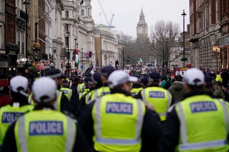 Police are seen at the rear of a march in London, where demonstrators were showing support for Palestinian people in Gaza.