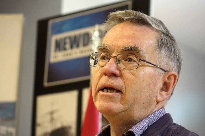 Close up of man with grey hair and glasses