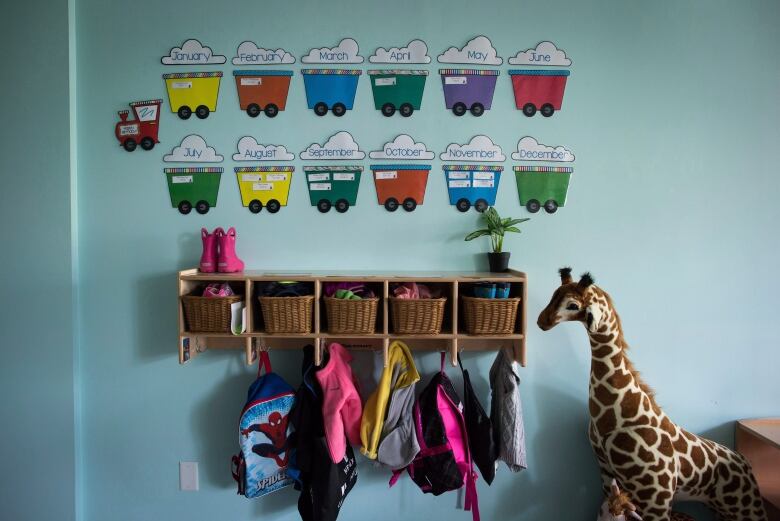 Cubby holes and backpacks hang on the wall of a daycare in Langley, B.C.