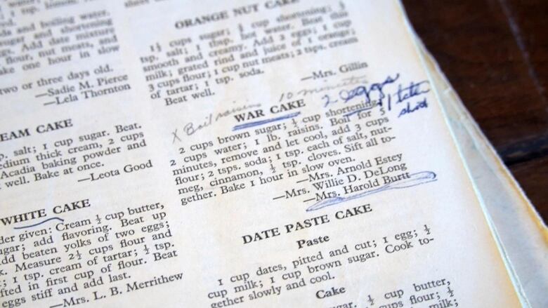 A close-up photo of a white page with a recipe for war cake typed on it along with someone's handwriting.