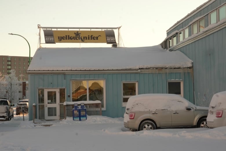 Sign on blue building reads 