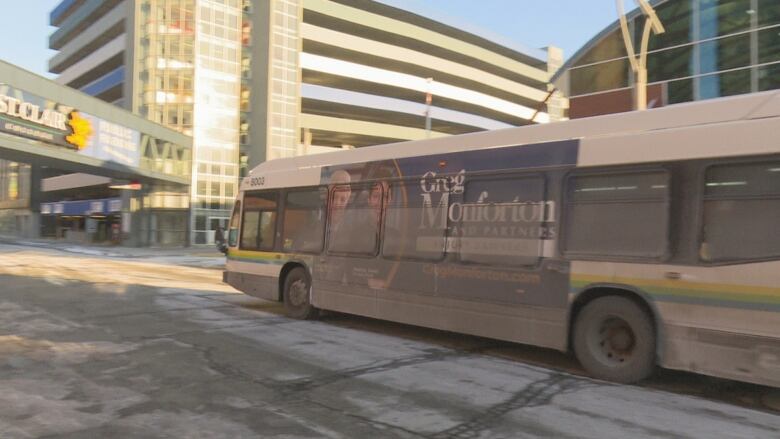 A bus leaving a terminal on a winter day.