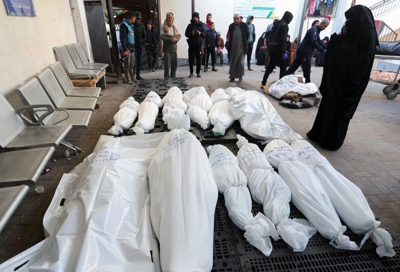 Mourners gather next to the bodies of Palestinians killed in an Israeli strike, amid the ongoing conflict between Israel and the Palestinian Islamist group Hamas, in Rafah in the southern Gaza Strip, January 18, 2024. 