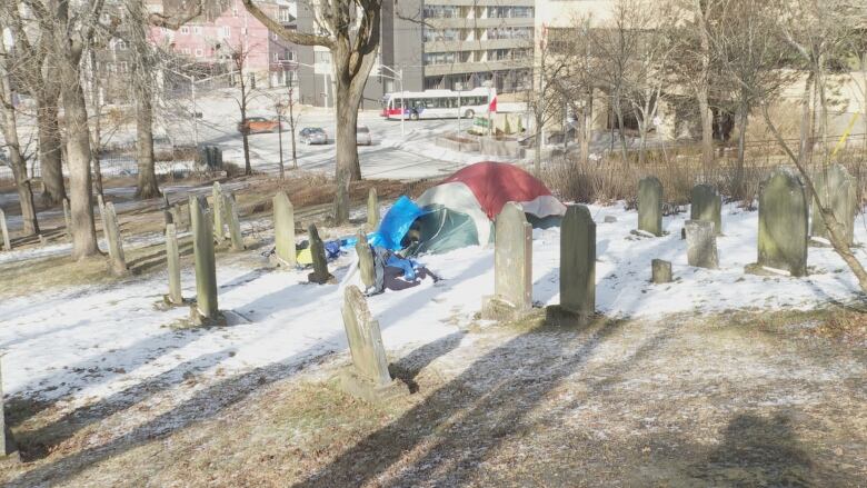 Tents erected between headstones. 