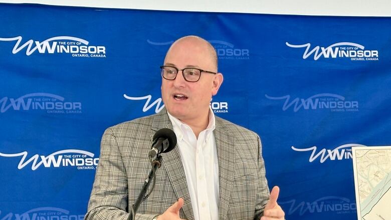 Dilkens speaking at a podium.