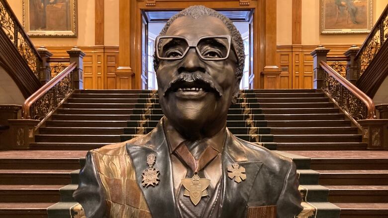 A bust beside the Canadian flag.