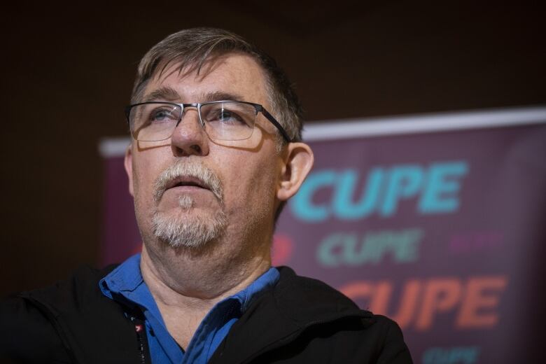 Liam O'Neill, CUPE National Representative photographhed during a press conference