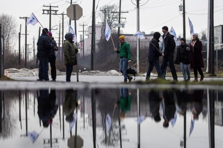 Picketers are pictured outside of the Coast Mountain Bus Company Vancouver Transit Centre in Vancouver, British Columbia on Tuesday, Jan. 23, 2024. 