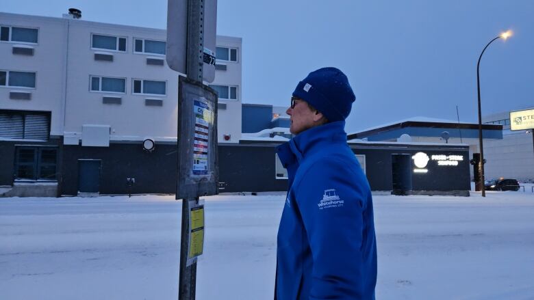 Mayor of Whitehorse, Yukon is looking at bus schedule posted outside of city hall.