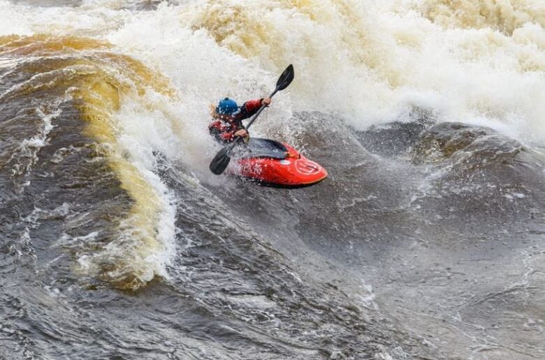 A kayak in whitewater rapids.