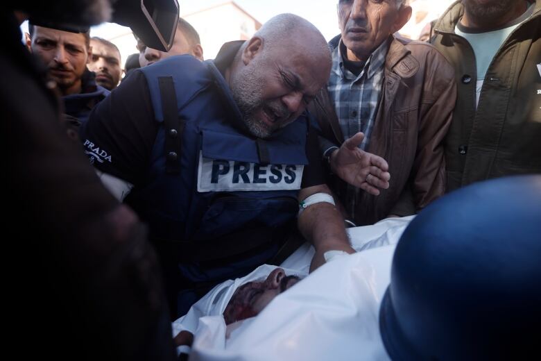 A man wearing a blue vest with the word 