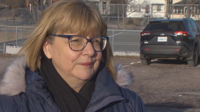 Ann Marie Danch stands outside her school. 