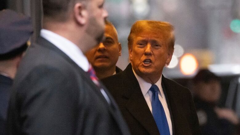 Former U.S. president Donald Trump is seen leaving his apartment building in New York.