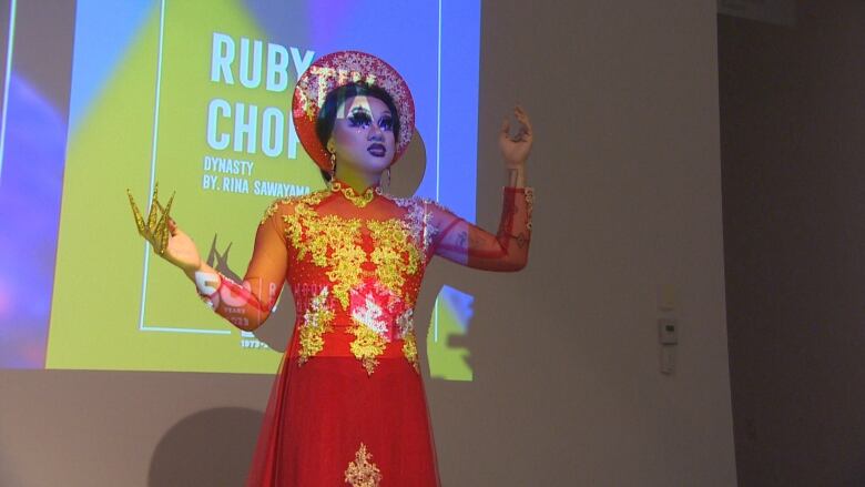 A drag artist performs in full costume. 