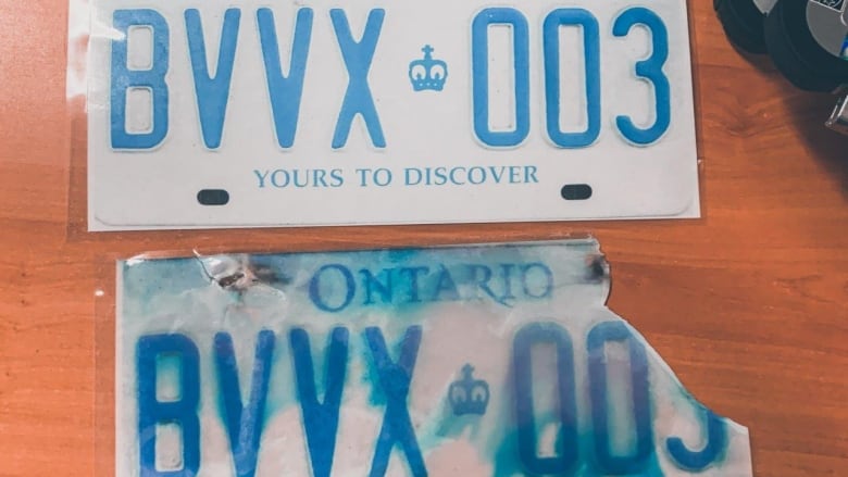 Two licence plates, one with blue smudged ink