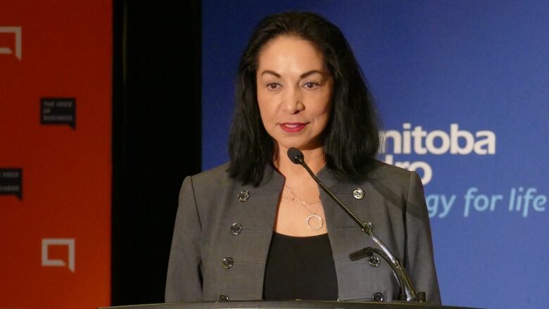 A woman speaks at a podium.