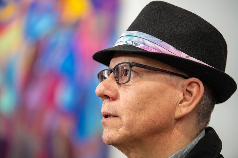 A man in a hat with glasses.