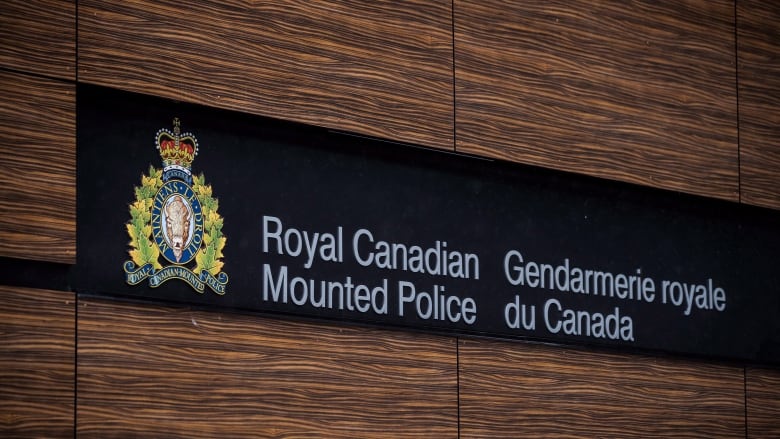 A sign on a wall says Royal Canadian Mountain Police. 