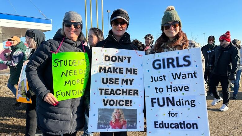 Teachers holding signs on a picket lines