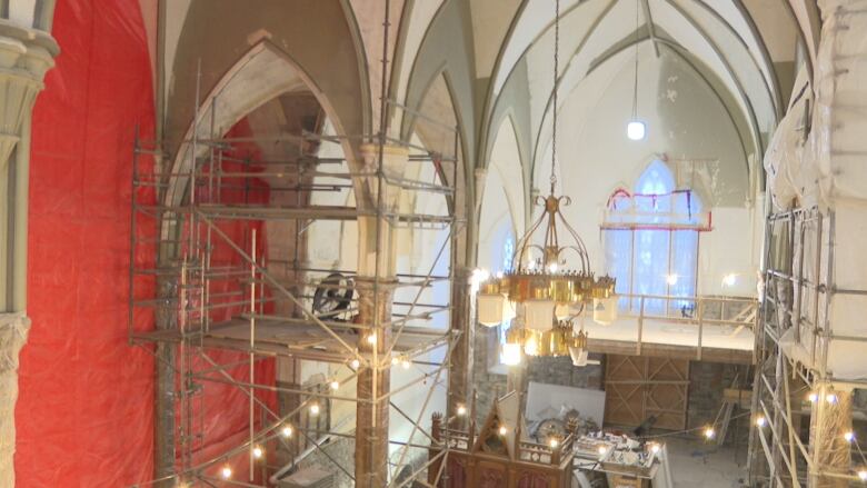 Scaffolding stands inside a church.