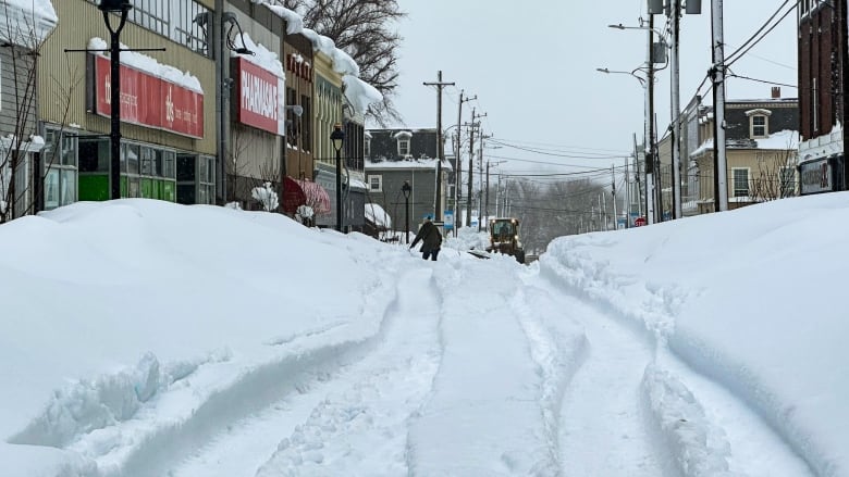 A woman makes her way on Charlotte St., Sydney after historic snowfall over the weekend. 