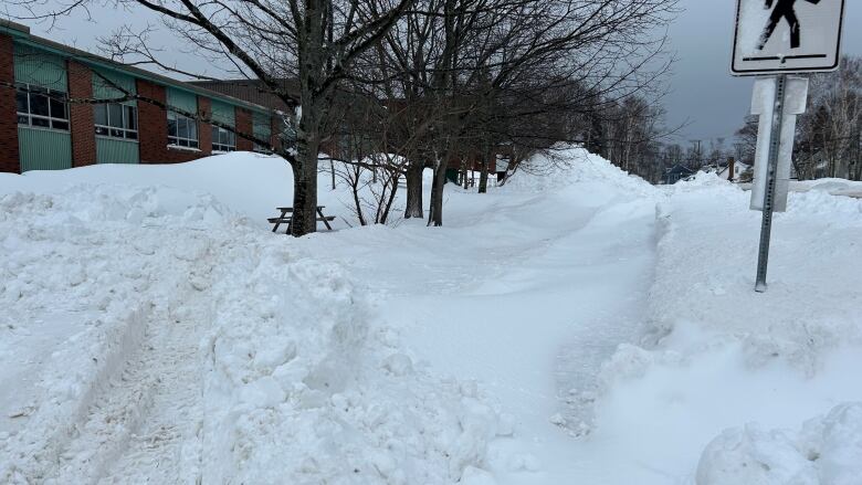 Snow piled on the sidewalk and in the parking lot of Spring Park School.