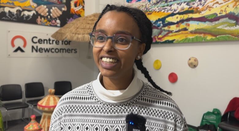 A woman smiles at the camera. 