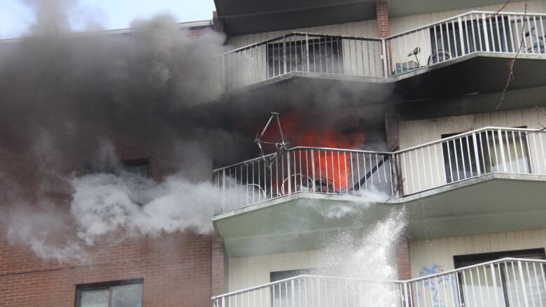 Flames shooting from a 7th floor unit at Wheelton Manor in Windsor, Ont.