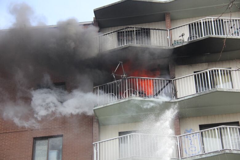 Flames shooting from a 7th floor unit at Wheelton Manor in Windsor, Ont.