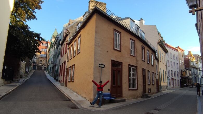 A girl posing in front of historic buildings in Old Quebec