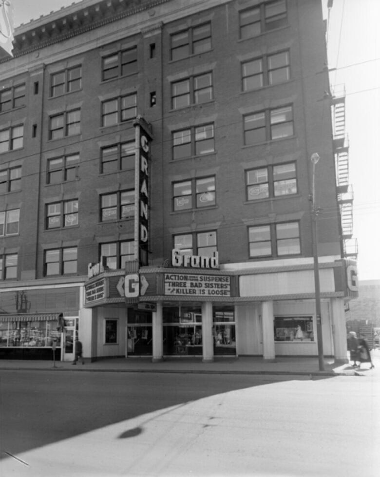 A black and white image shows the exterior of a building.