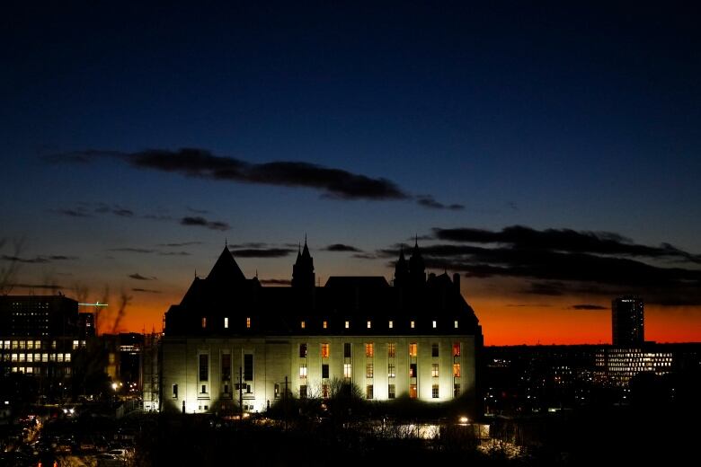 The high court pictured at night.