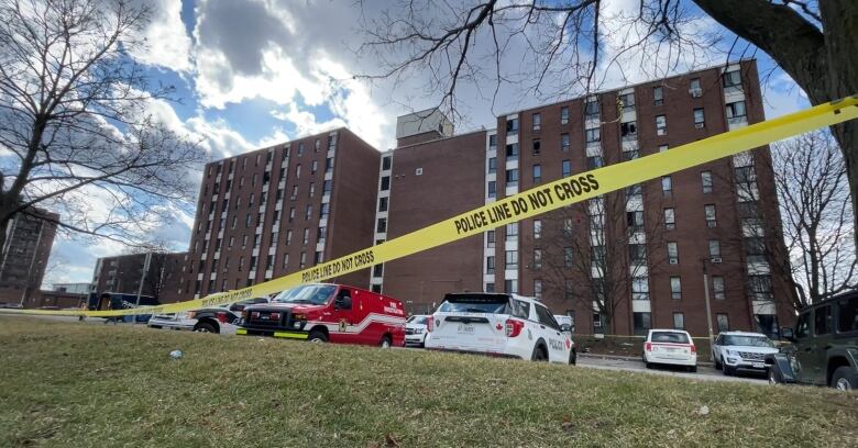 Police tape in front of an apartment building