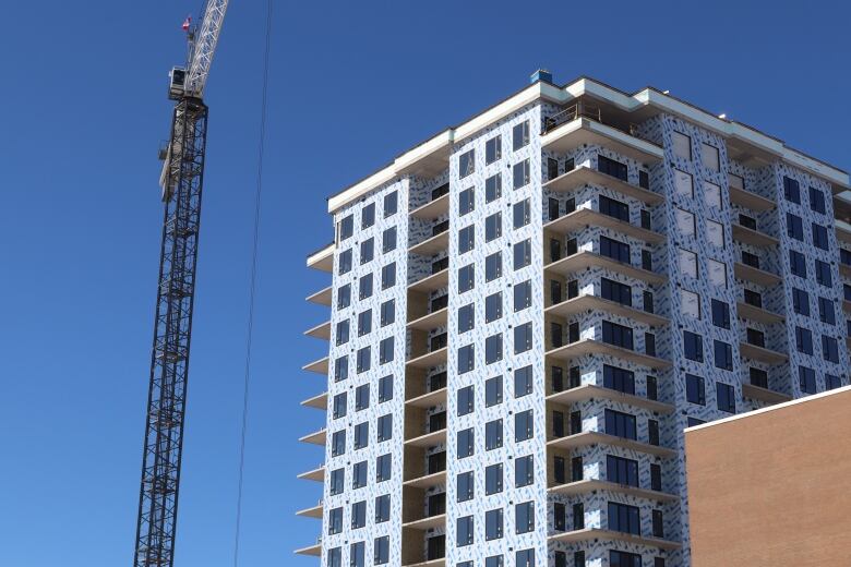 apartment under construction with crane