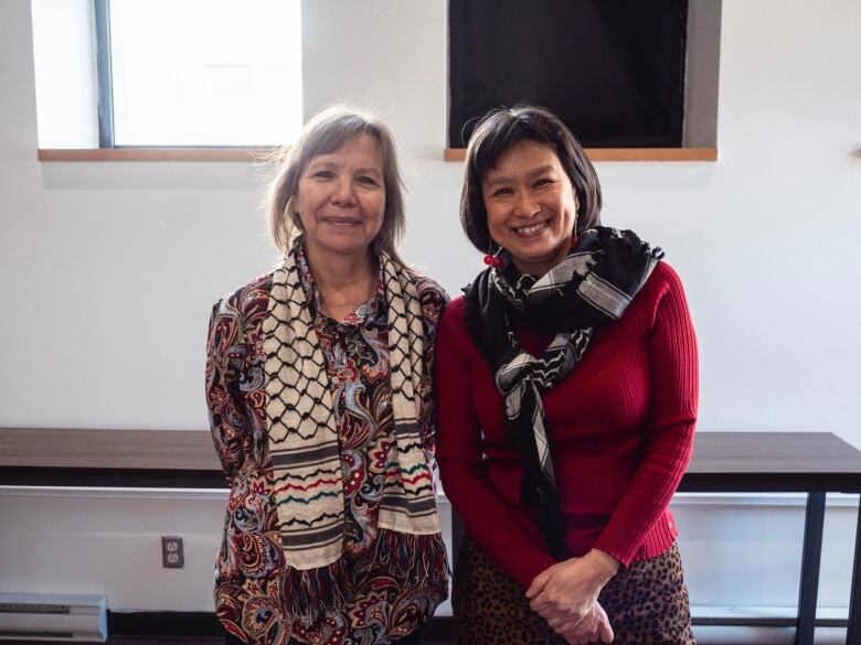 Two women smile for a photo together. 